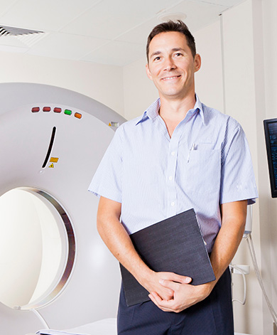 A technician stood in front of medical imaging equipment