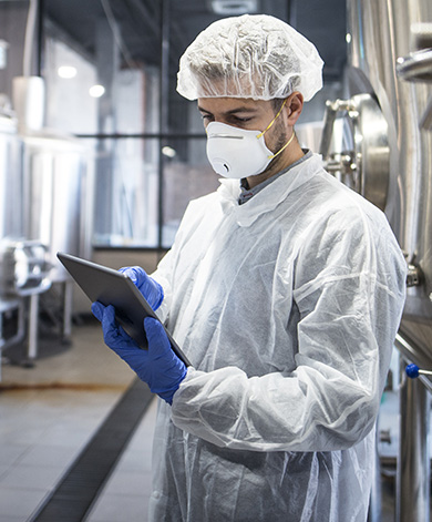 A hygiene specialist wearing full PPE